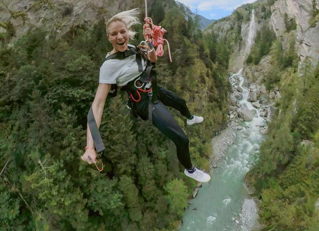 Woman hangs from a bungee cord over the gorge